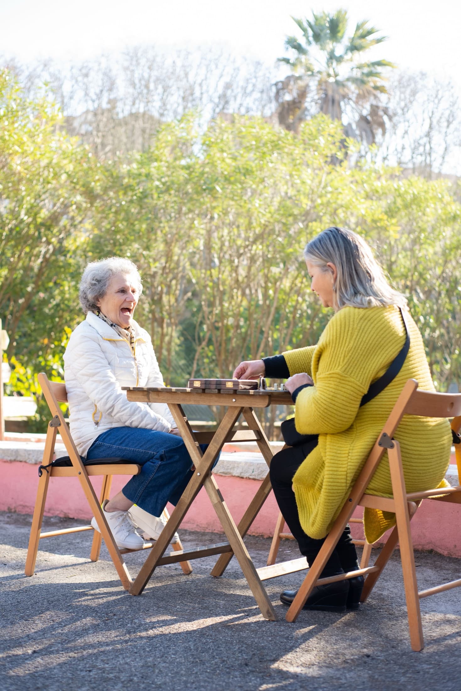 Two women enjoying a game outdoors in the sunshine
