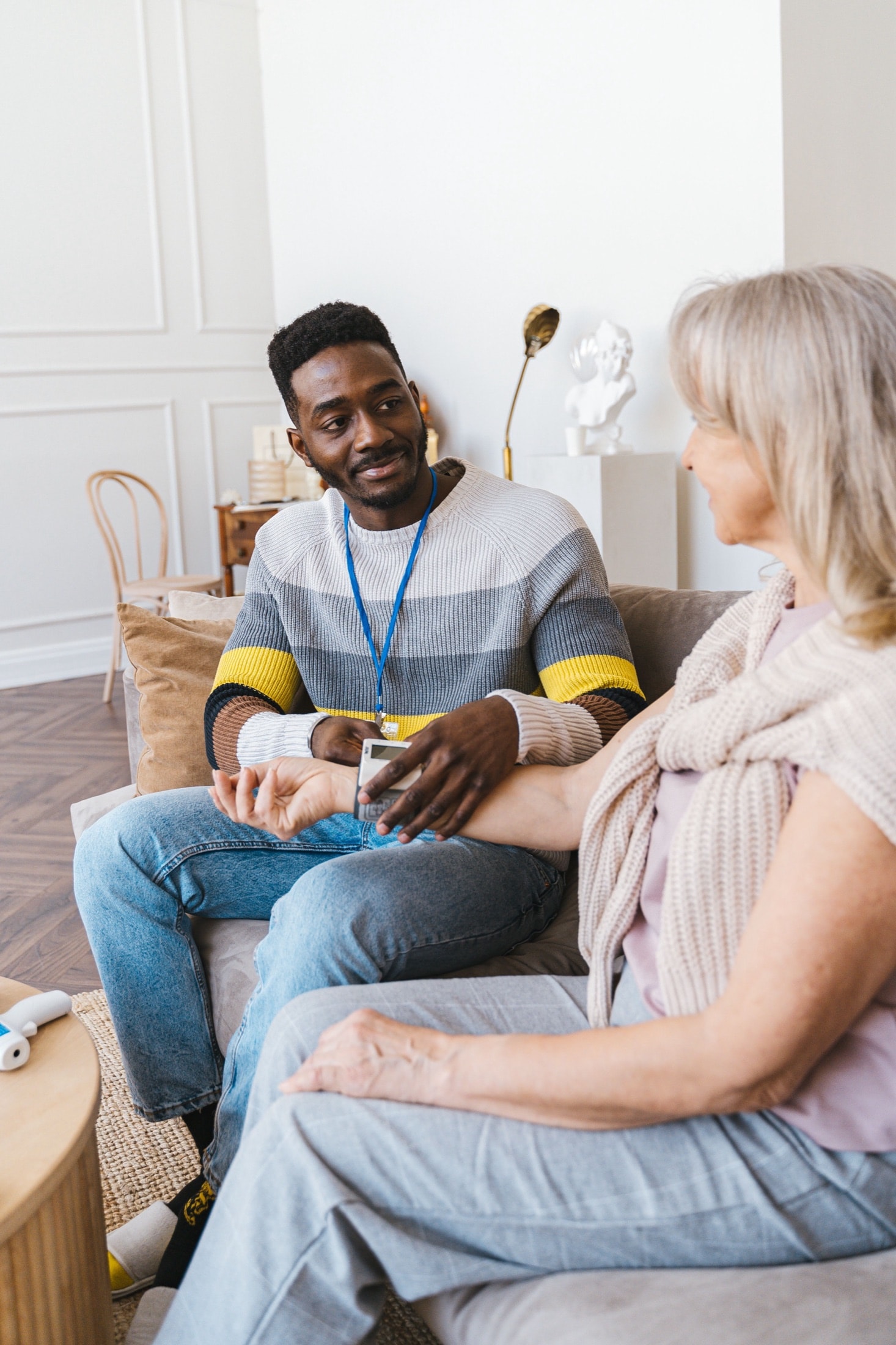 A caregiver checking on a resident in her sitting room