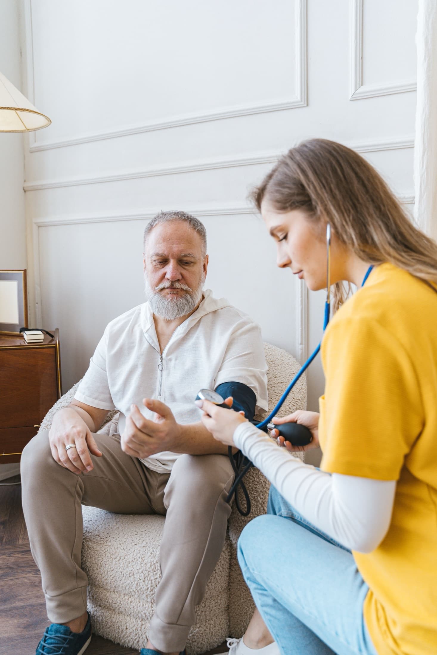 A resident having a health check with a member of staff