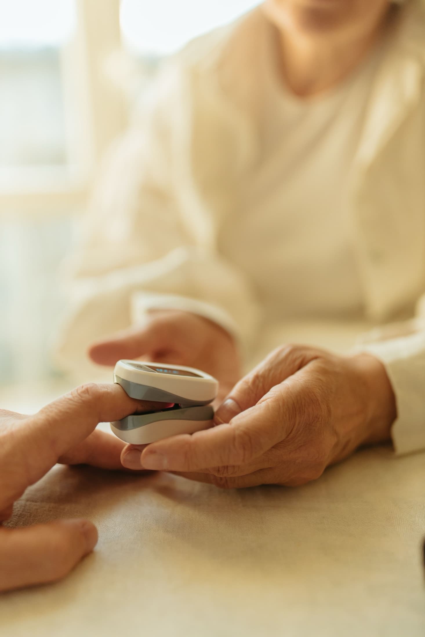 A staff member checking a resident's health readings